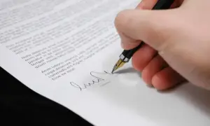Podpisanie dokumentu, który może dotyczyć dziedziczenia, piórem wiecznym.